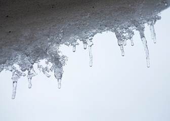 Icicles and sunlight. Icicles. The melting of the ice. The spring thaw. Warm winter . The icicles close.