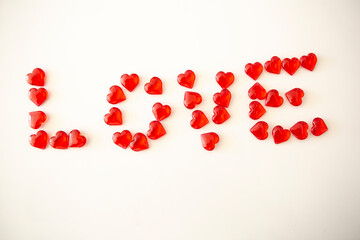 Word "Love" on a white background formed with little red hearts