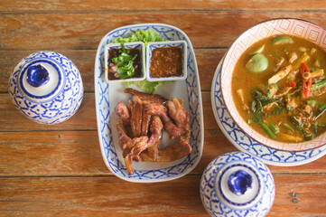 close up of Thai food on the wooden table.