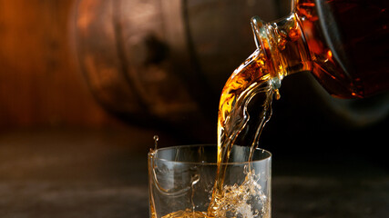 Whiskey Liquid falling into Glass, Freeze Motion. - obrazy, fototapety, plakaty
