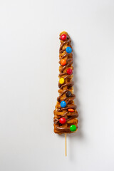 Waffles Stick, topping of chocolate and chocolates candies (red,blue,orange,yellow, green and brown) White background