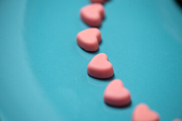 Pink hearts on a blue pastel background. Valentine```s day concept