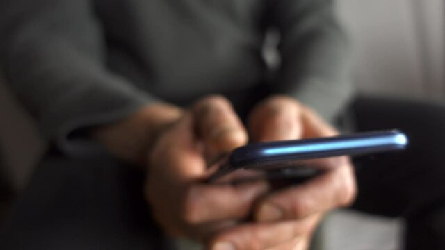 A man texting writing and messaging with thumbs on a smartphone.Untitled Project