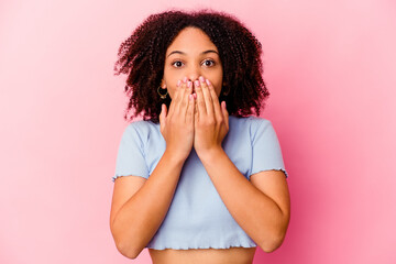 Young african american mixed race woman isolated shocked covering mouth with hands.