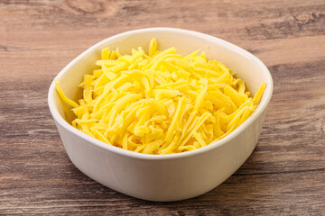 Shredded yellow cheese in the bowl