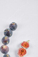 Whole fig and fig slices on a white background
