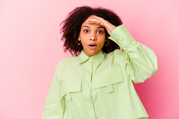 Young african american mixed race woman isolated looking far away keeping hand on forehead.