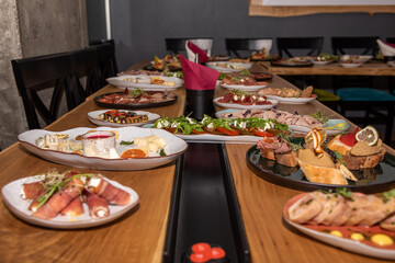 set table with delicious salads and snacks. Horizontal top view. Selective focus. Celebration concept and set table with food