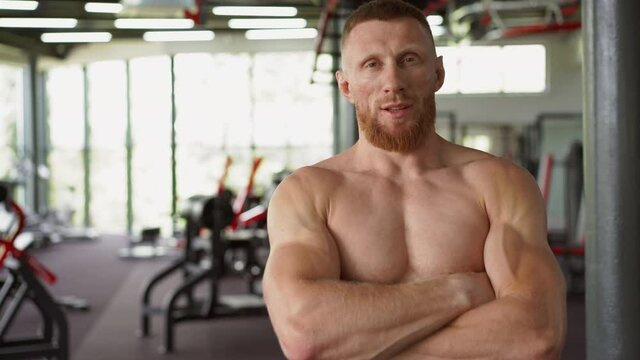 Athlete sportive man gym Middle adult handsome sportsman bodybuilder weightlifter ideal body after training abs muscles biceps triceps Arms crossed trainer standing indoor naked torso 