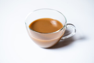 Clear glass of white coffee on white background