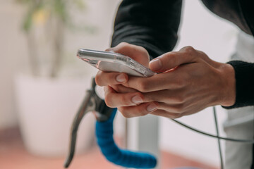 hands with mobile phone on the bicycle