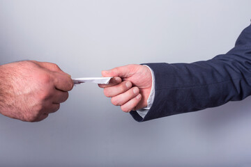 Two men with blank card in his hand close up