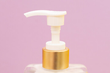 Plastic white bottles with dispenser pumps isolated on pink background. spa concept