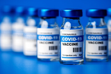 covid-19 vaccine - coronavirus vaccination bottles. injection vials in a row