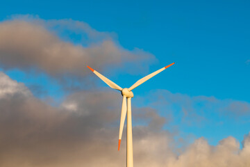 wind turbine in the sky. Wind turbine in a wind farm in winter. wind turbine with lots of blue clouds in background. Wind energy in Germany