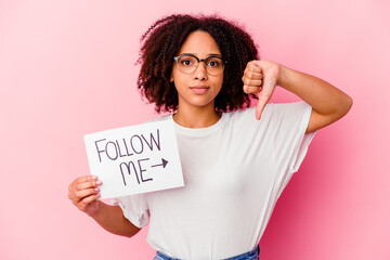 Young african american mixed race woman holding a follow me concept showing a dislike gesture,...