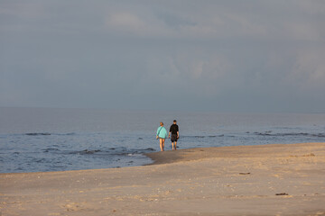  Romantic walk of a couple in love on the beach in Stegna, Pomerania. Poland