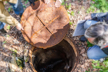 Inspection of the sewer hatch. The removed storm sewer manhole cover
