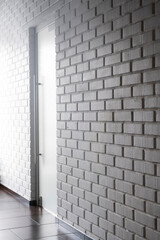 interior with frosted glass door on white brick wall