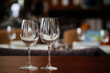 two empty clean wine glasses on a wooden table. utensils for alcoholic beverages. serving the table.