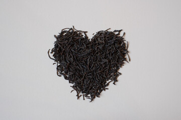 Black tea leaves in heart shape. Organic dry black tea with bergamot flavour for making hot tea....