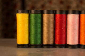 Multicolored thread spools lined as a row
