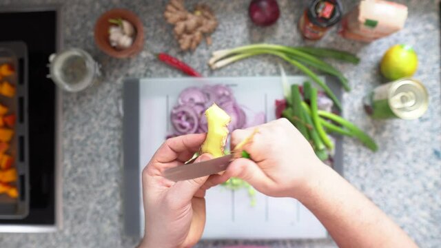 Image Of Person Hands Peeling Ginger At Kitchen. - Close Up Shot, Selective Focus