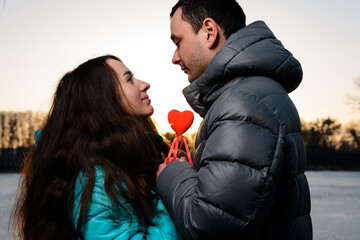 Loving couple in the park on Valentine's Day, walking in the evening park for two, romantic evening.