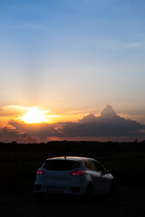 Fototapeta na wymiar hatchback car on sunset