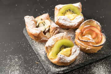 Home made puff pastries on dark background
