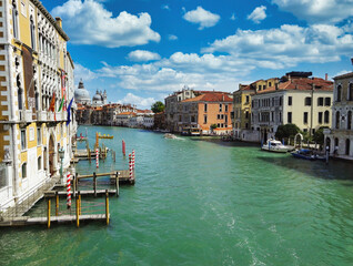 Venice, Italy - September 02, 2018: Wide angle shot from Rialto bridge showing grand canal between Italian colorful building against dramatic clouds during summer