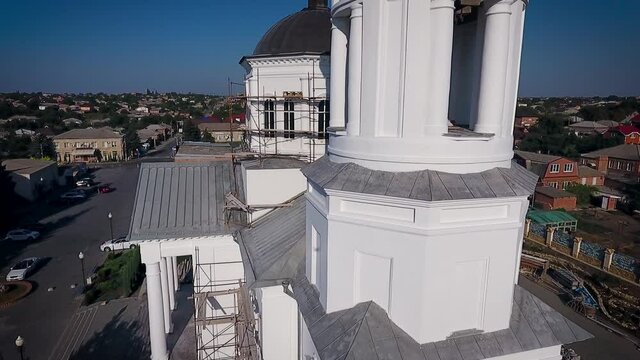 Aerial view of a christian cathedral with bell tower and domes.
