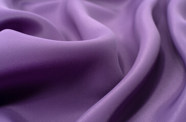 A piece of purple cloth. Fabric texture for background and design works of art, beautiful wrinkled...