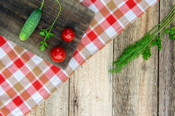 Fresh cucumber with leaves on a wooden table. The rural style. High quality photo