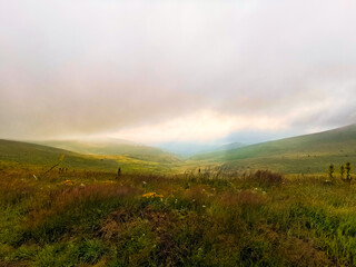 Morning sunrise, and sunrays trought mist in the mountains.