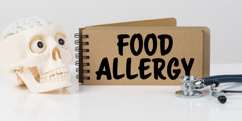 On the table lies a skull, a stethoscope and a notebook with the inscription - FOOD ALLERGY
