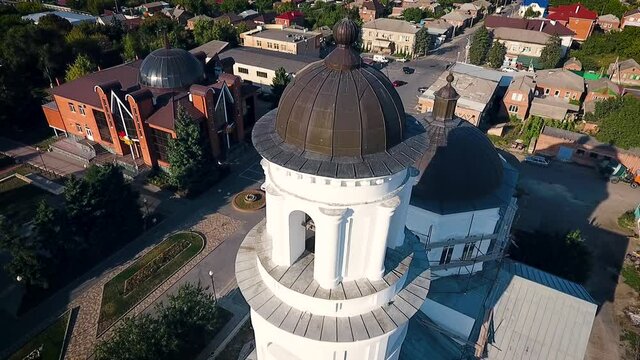 Aerial view of a christian cathedral with bell tower and domes.