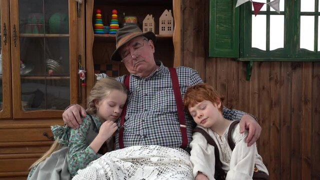 4K. In Geppetto's carpentry shop, Papa Carlo fell asleep reading a book to his grandchildren. Children's fairy tales about the creation of Pinocchio, a wooden doll with a long nose.