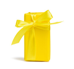 rectangular box with a gift wrapped in yellow paper and tied with a silk yellow ribbon