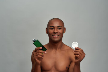 Adult man raising cotton pad and lotion © Svitlana