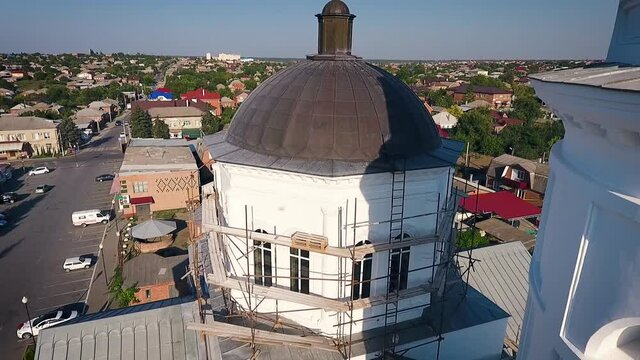 Aerial view of a christian cathedral with bell tower and domes.