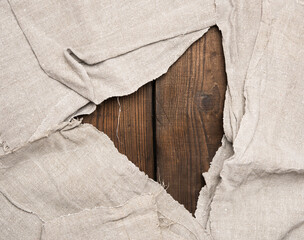 gray kitchen towel on brown wooden background,