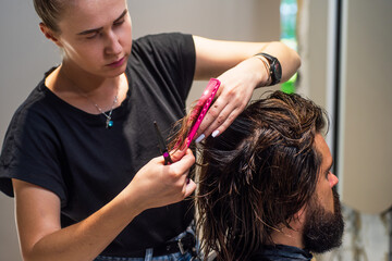 Fototapeta premium Portrait of stylish man and Barber master with scissors and brush, barbershop
