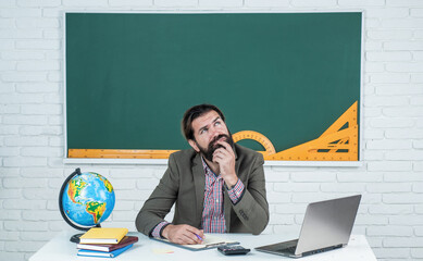 Dream of Success. male student sit in school classroom on lesson with blackboard. pass the exam....