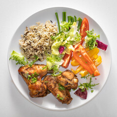 Wild rice, baked chicken wings salad plate with healthy food.