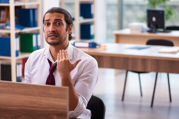 Young male employee and too many work in the office