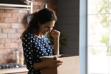 Overjoyed young Caucasian woman buyer feel euphoric with good quality product shopping online on...