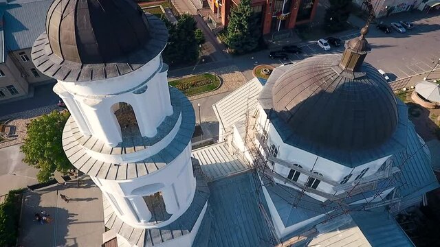 Aerial view of a christian cathedral with bell tower and domes.