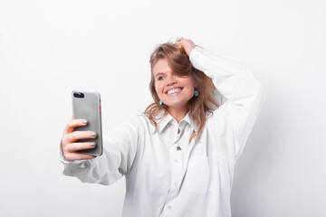 Photo of young charming woman making selfie with smartphone.