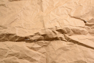 brown crumpled paper with torn holes
